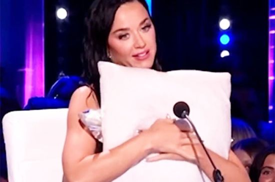 KATY PERRY CLINGS TO A PILLOW AS SHE EXPERIENCES WARDROBE MALFUNCTION